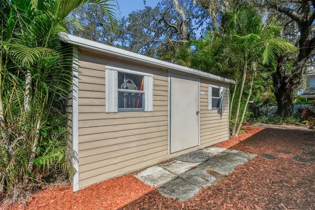 a view of yard with tree in the background