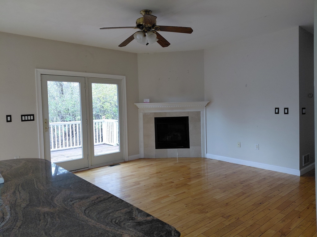 218 Lowell Street Lexington, MA 02420 - Photo 15 of 42 a view of an empty room with a window and wooden floor