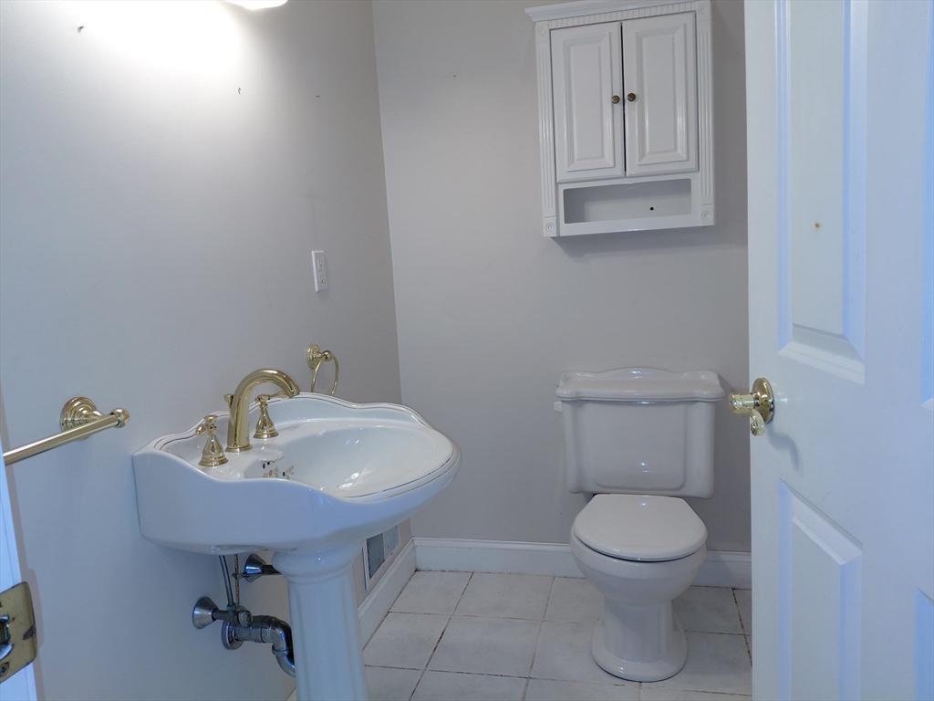 218 Lowell Street Lexington, MA 02420 - Photo 17 of 42 a bathroom with a toilet sink and mirror