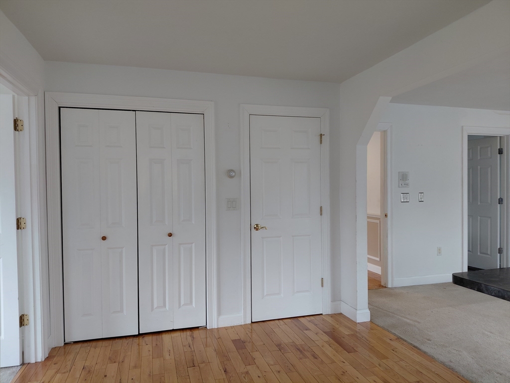 218 Lowell Street Lexington, MA 02420 - Photo 24 of 42 a view of an empty room with wooden floor