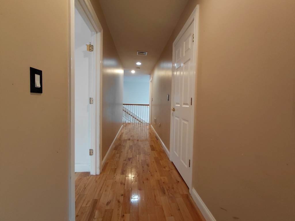 218 Lowell Street Lexington, MA 02420 - Photo 28 of 42 a view of a hallway with wooden floor