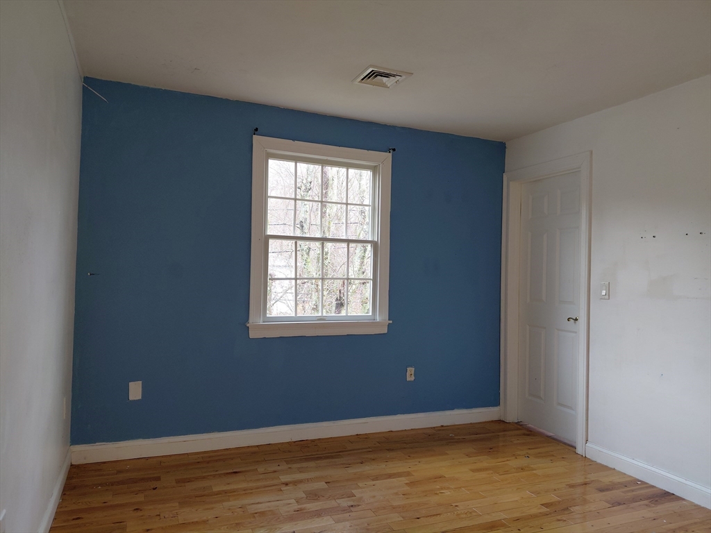 218 Lowell Street Lexington, MA 02420 - Photo 29 of 42 an empty room with wooden floor and windows