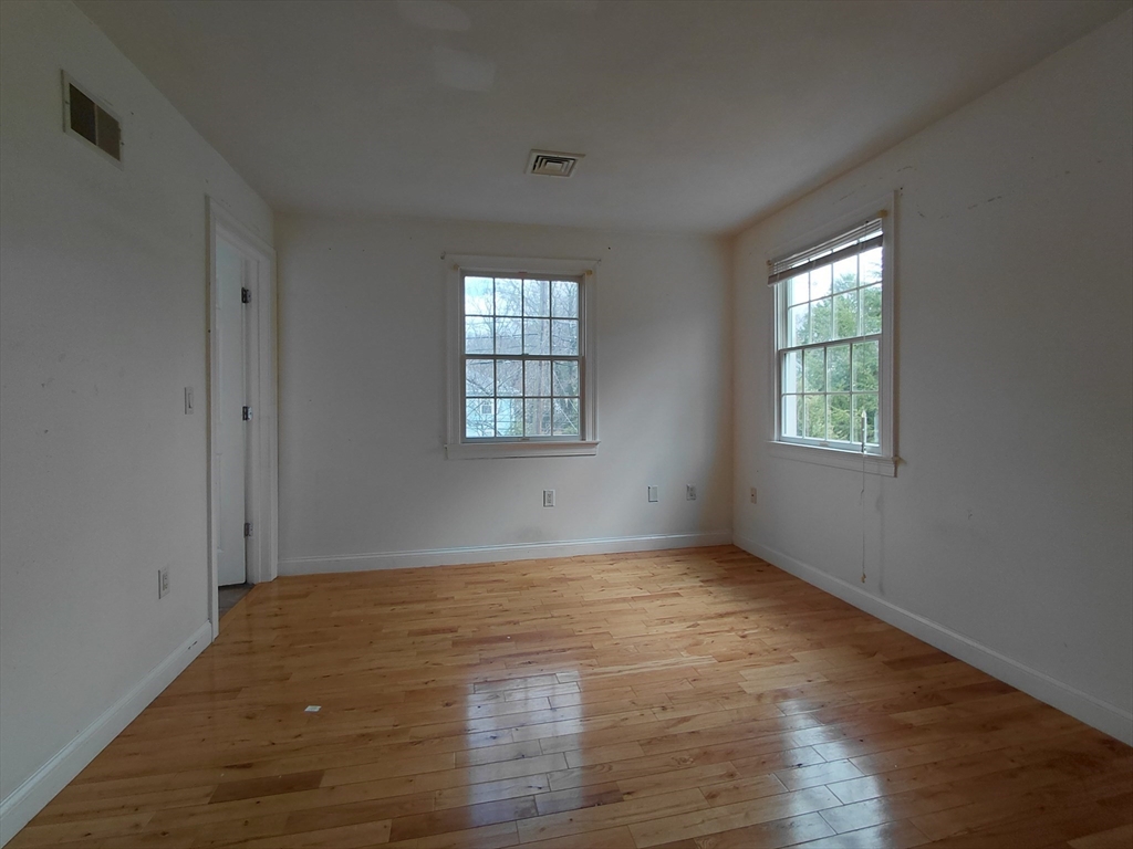 218 Lowell Street Lexington, MA 02420 - Photo 32 of 42 an empty room with wooden floor and windows