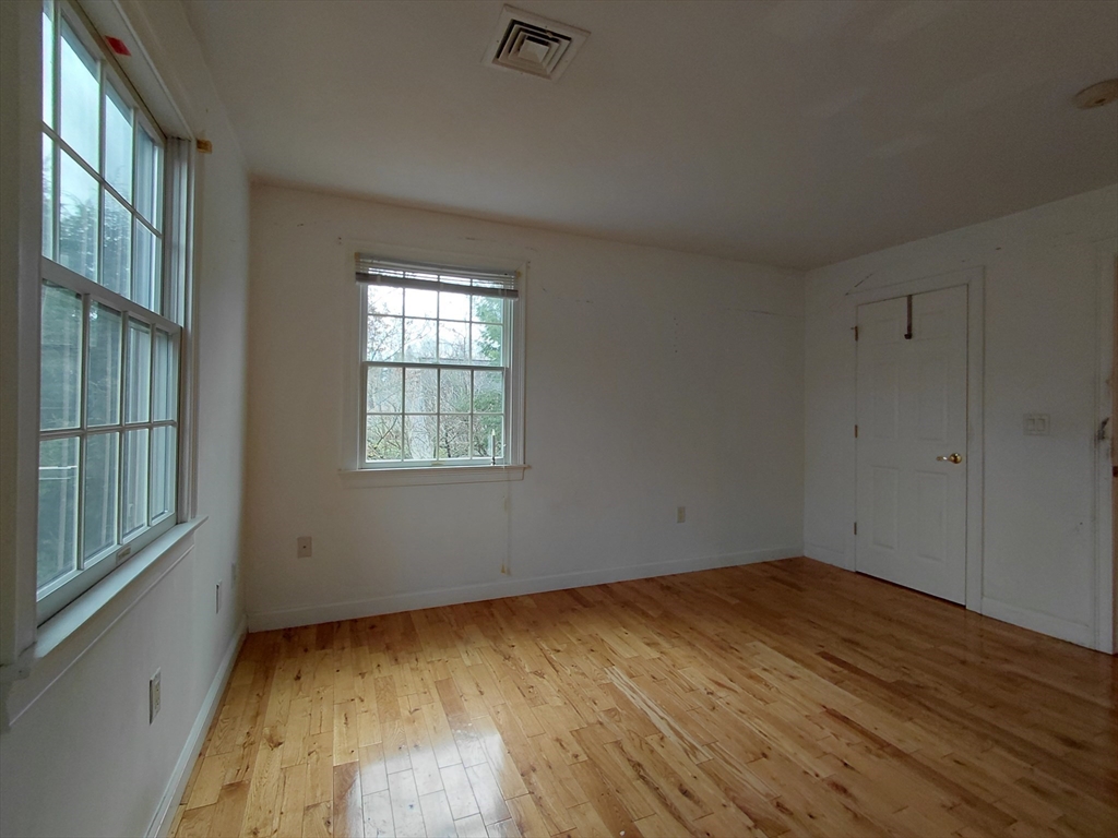 218 Lowell Street Lexington, MA 02420 - Photo 33 of 42 an empty room with wooden floor and windows