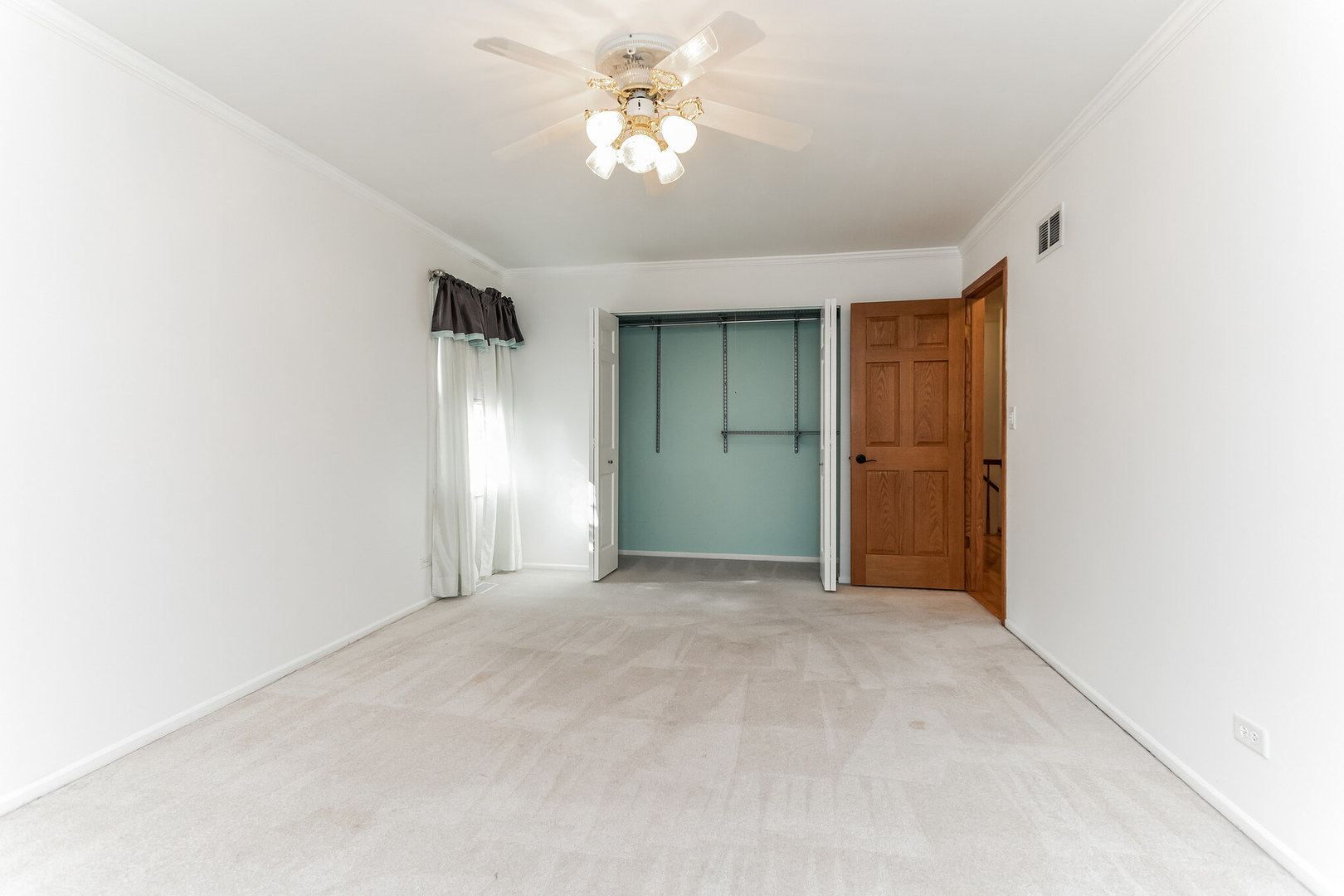 508 North Walnut Lane Schaumburg, IL 60107 - Photo 17 of 25 an empty room with closet and a chandelier fan
