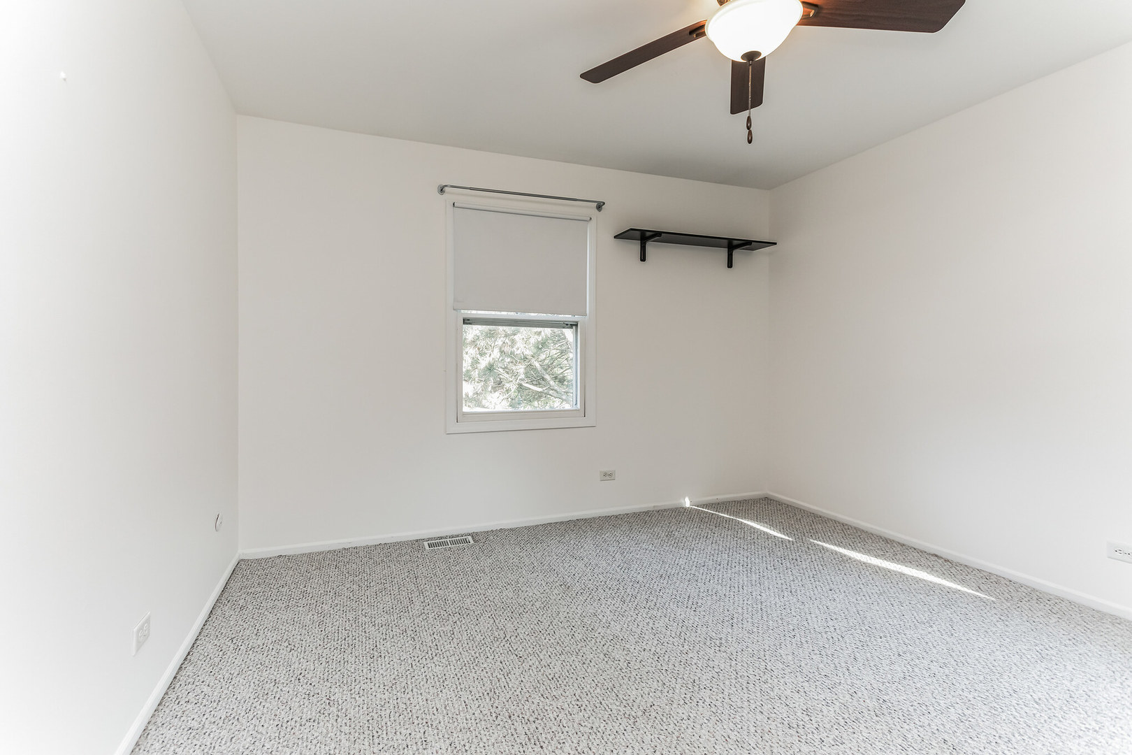 508 North Walnut Lane Schaumburg, IL 60107 - Photo 19 of 25 an empty room with a window and a ceiling fan
