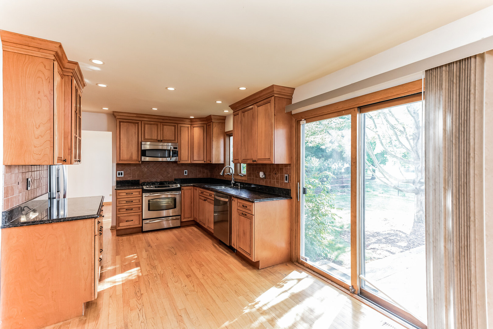 508 North Walnut Lane Schaumburg, IL 60107 - Photo 9 of 25 a kitchen with stainless steel appliances granite countertop a stove a sink and a refrigerator