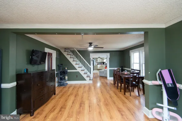 a dining room with furniture and wooden floor