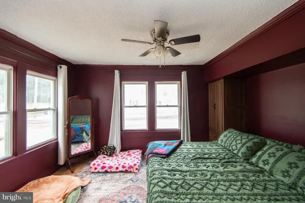 a bedroom with bed and a window