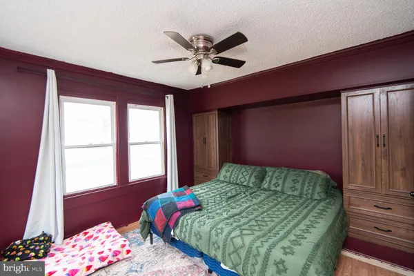 a bed sitting in a bedroom next to a window