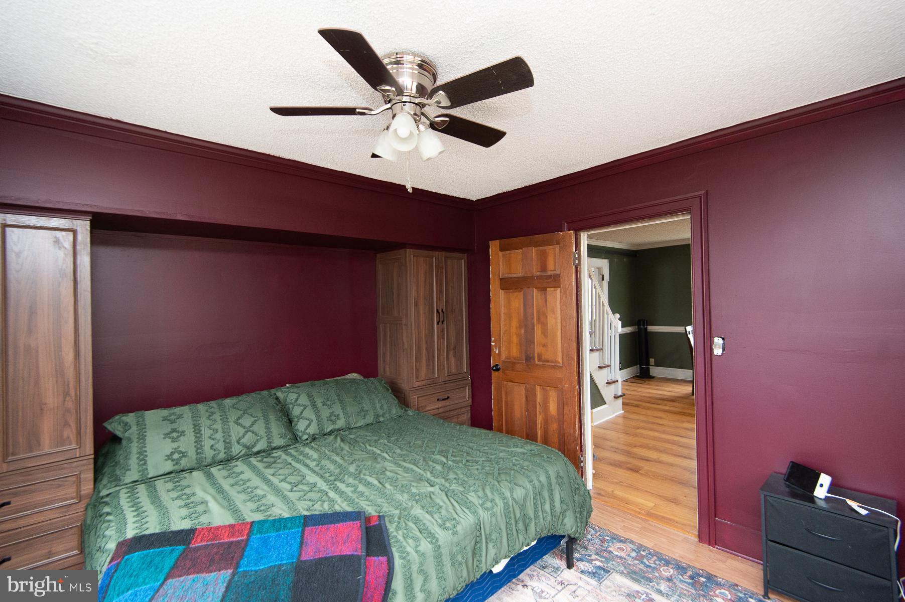 2537 Old House Point Road Fishing Creek, MD 21634 - Photo 26 of 37 a bedroom with a bed and a chandelier