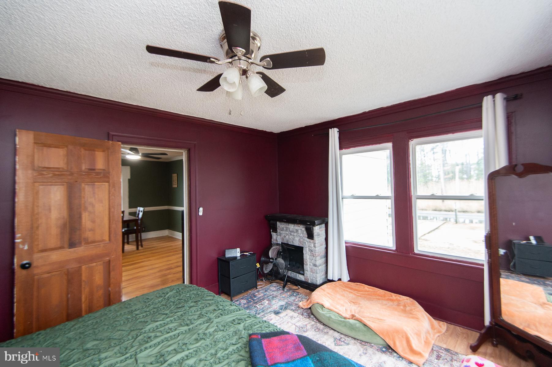 2537 Old House Point Road Fishing Creek, MD 21634 - Photo 27 of 37 a bedroom with a bed and a chandelier