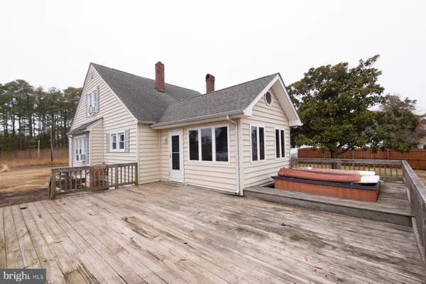 a front view of house with deck and yard