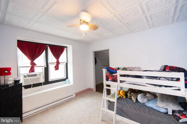 a bedroom with furniture and a window
