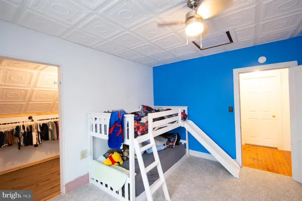 a bedroom with furniture and a book shelf