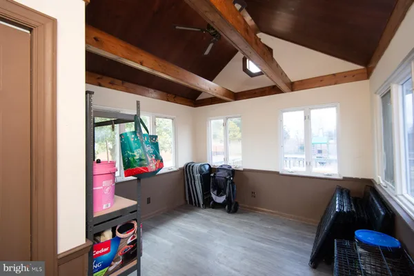 a living room with furniture a flat screen tv and a large window