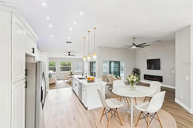 an empty room with wooden floor cabinet and windows