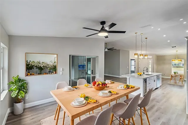 a view of a hallway with wooden floor and door