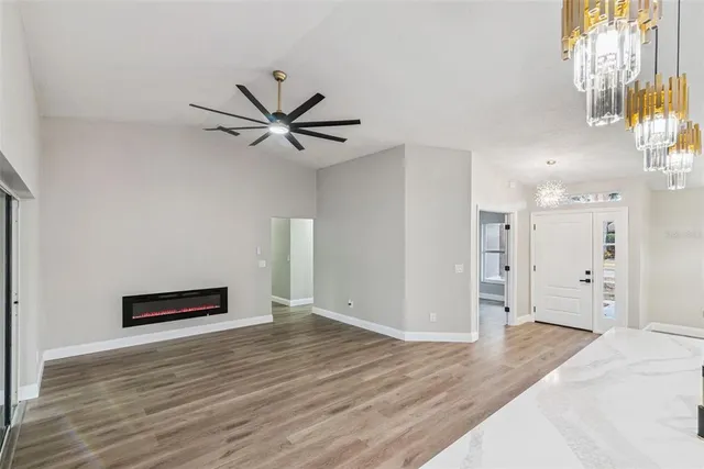 a view of a swimming pool with a patio and a backyard