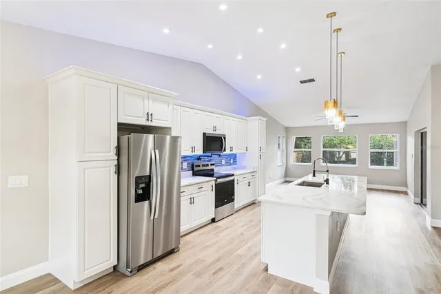 a view of a kitchen with wooden floor and a counter top space