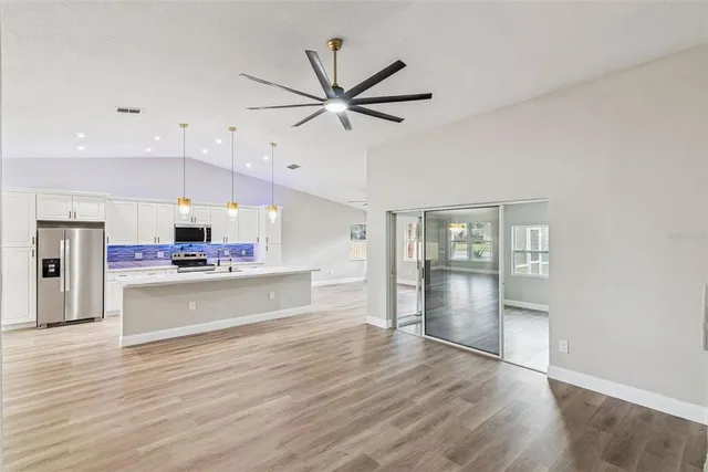 a view of a dining room with furniture a fireplace and wooden floor