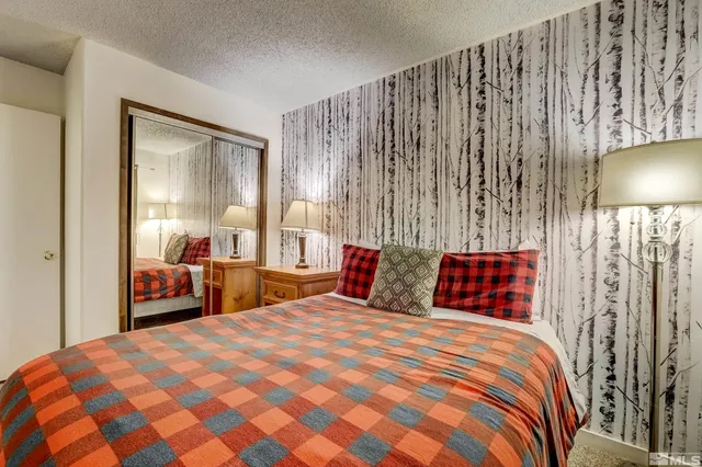 a bedroom with a large bed and a chandelier