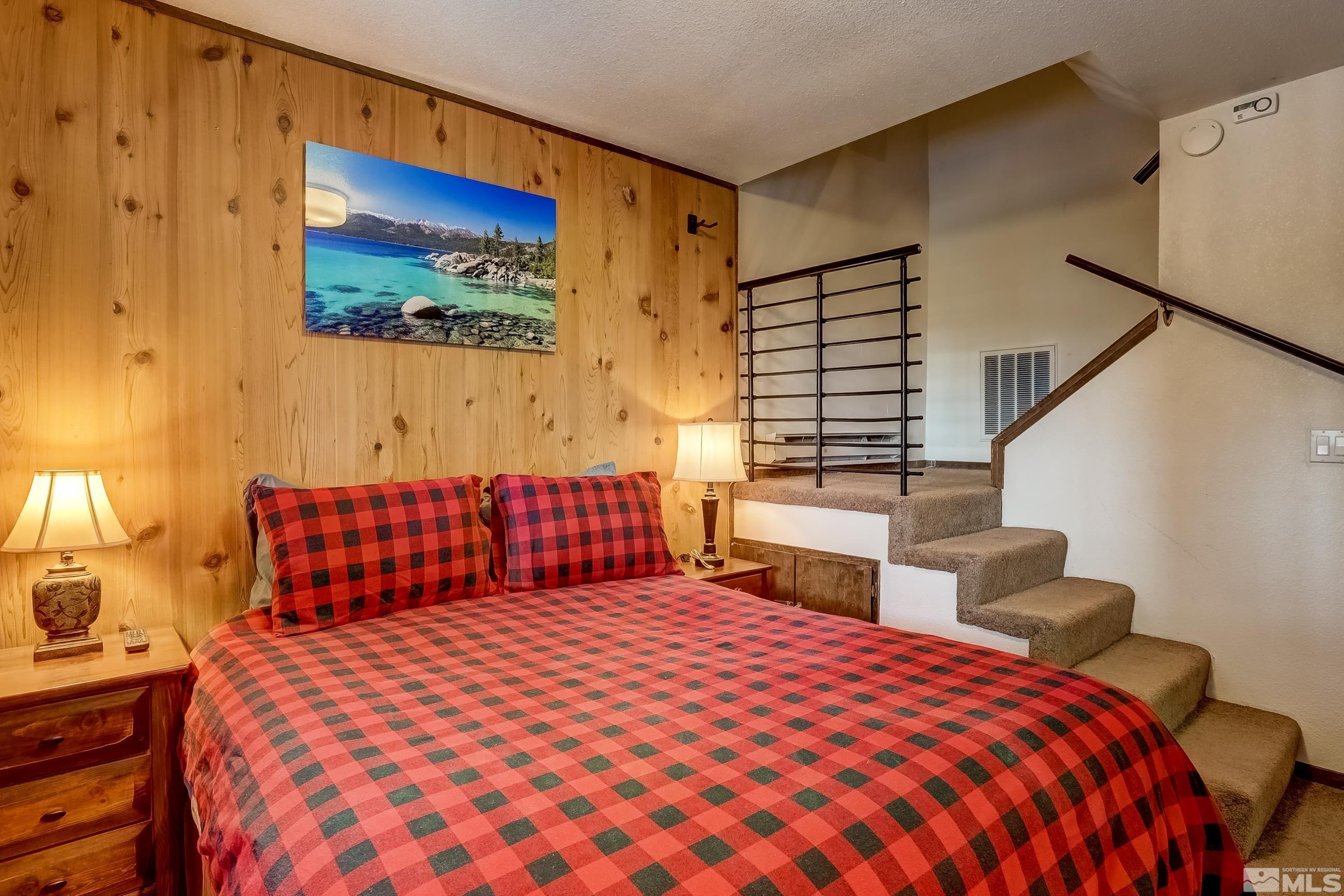 758 Milky Way Court, Unit B Stateline, NV 89449 - Photo 16 of 36 a bedroom with a bed and wooden floor