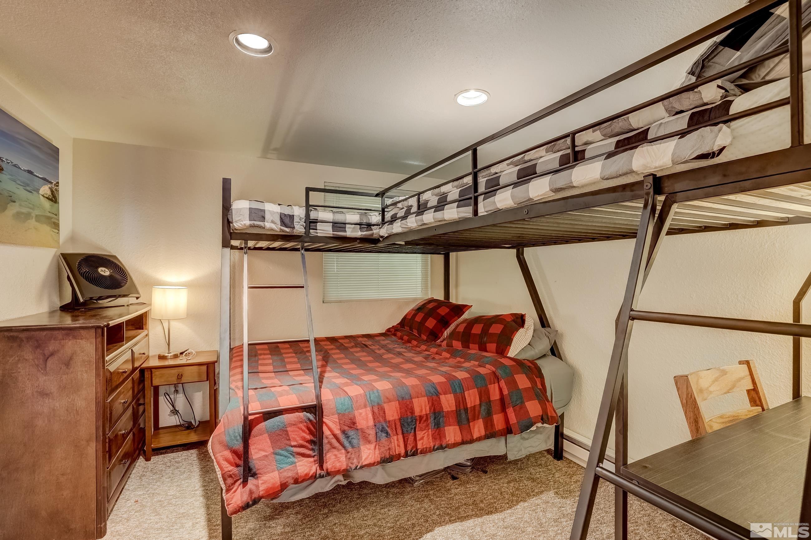 758 Milky Way Court, Unit B Stateline, NV 89449 - Photo 18 of 36 a bedroom with a bed and a mirror