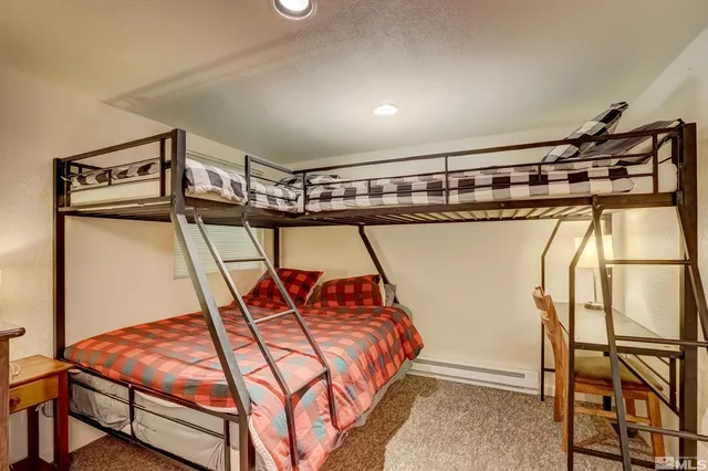 a bedroom with table and white wooden floor