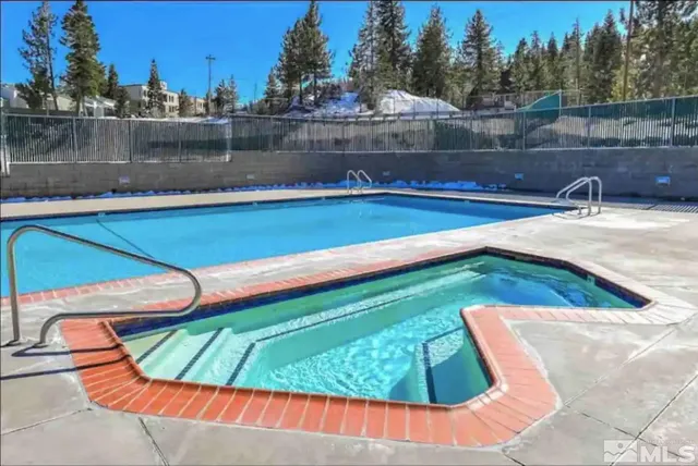 a view of a swimming pool with a yard