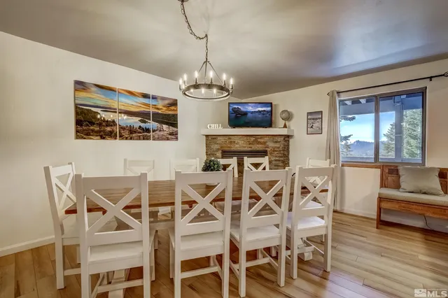 a view of a dining room with furniture wooden floor and chandelier