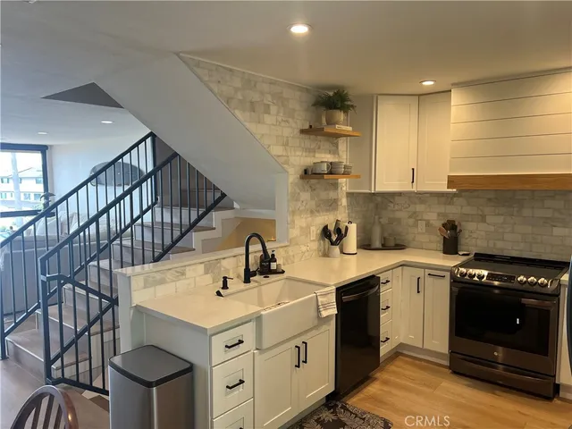 a kitchen with a sink cabinets and appliances