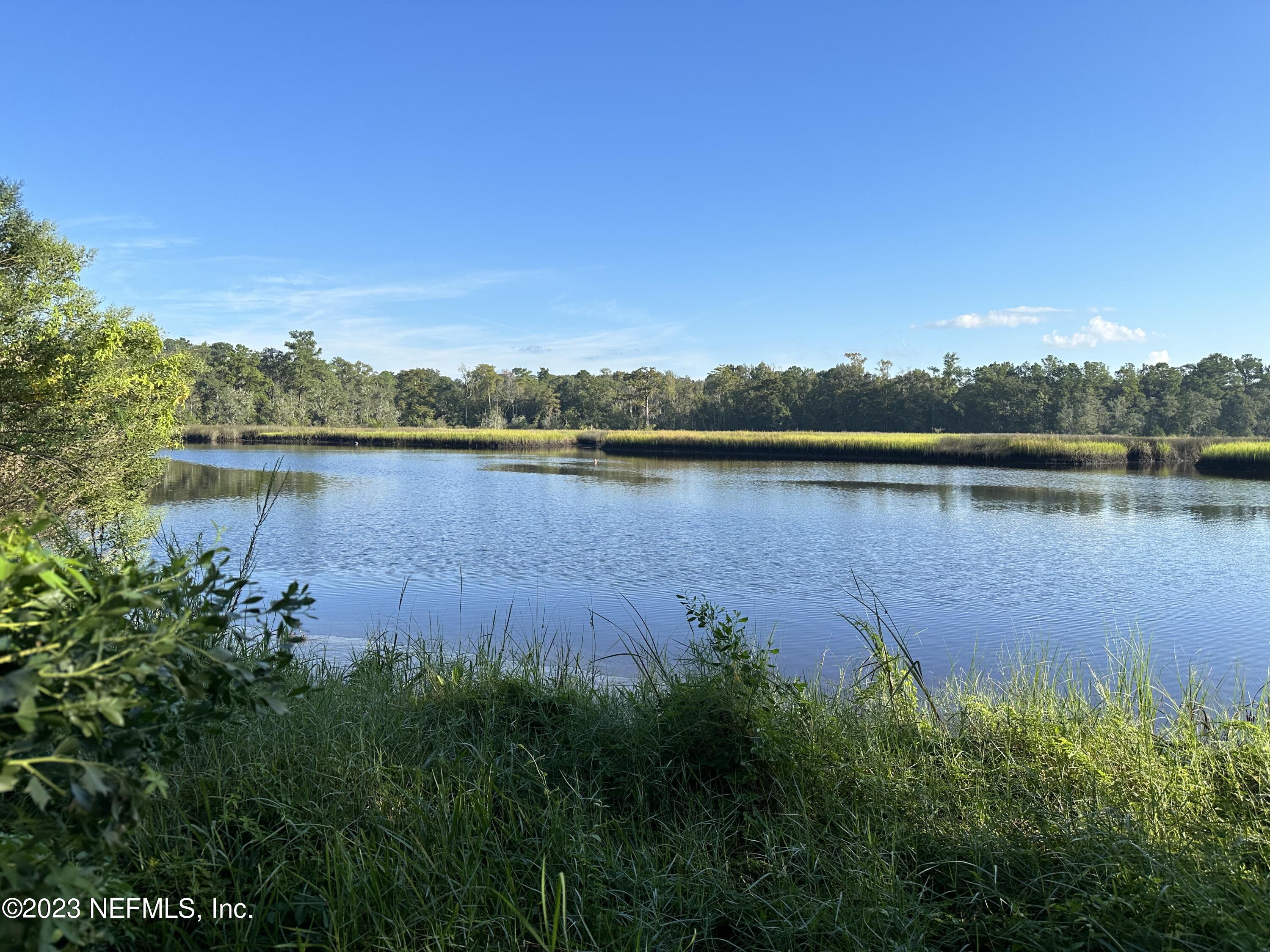 2827 Ribault Scenic Drive Jacksonville, FL 32208 - Photo 23 of 24 a view of a lake with houses in the back