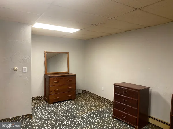 a room with a dresser and a mirror