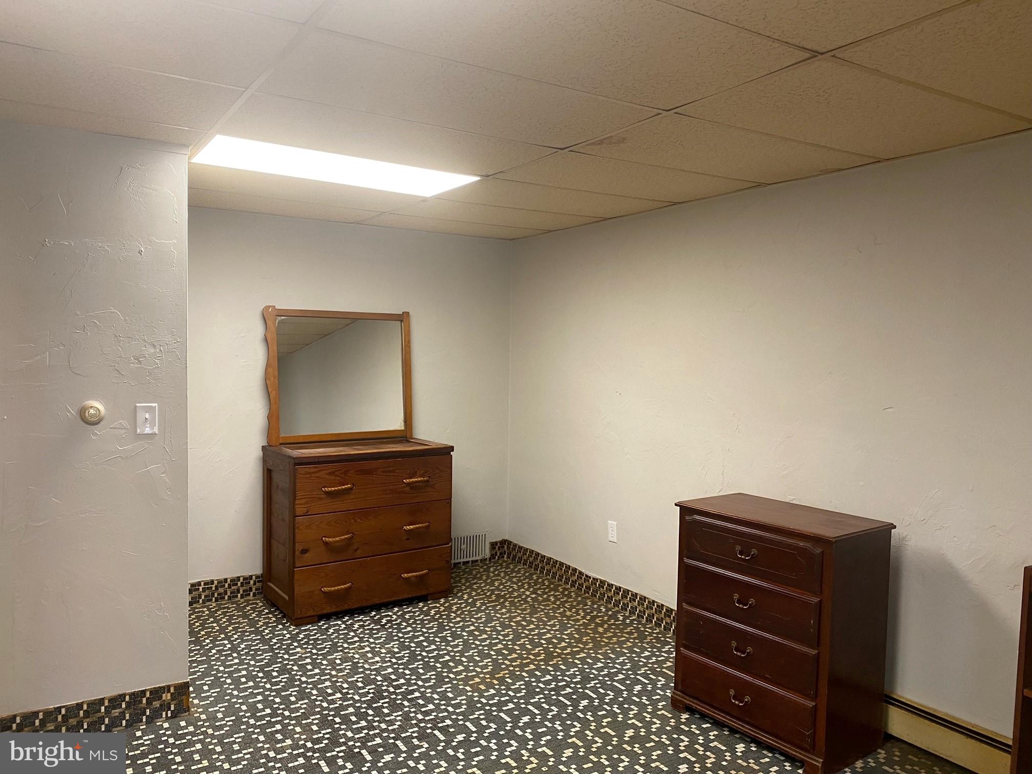 17 South 2nd Street, Unit F Quakertown, PA 18951 - Photo 1 of 2 a room with a dresser and a mirror