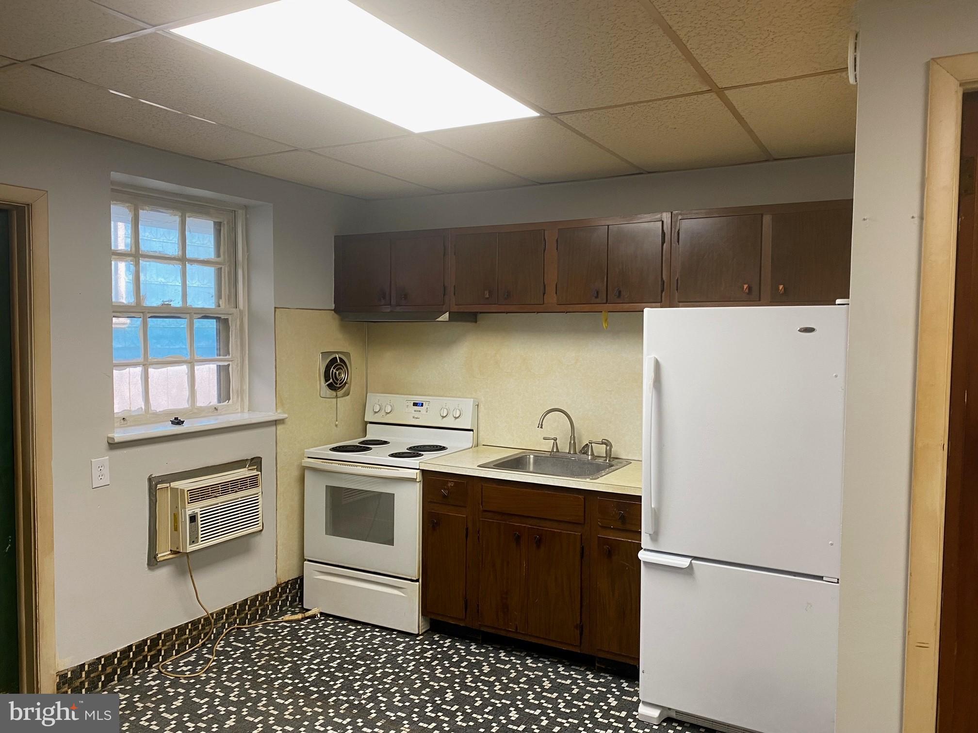 17 South 2nd Street, Unit F Quakertown, PA 18951 - Photo 2 of 2 a kitchen with a sink a stove and refrigerator