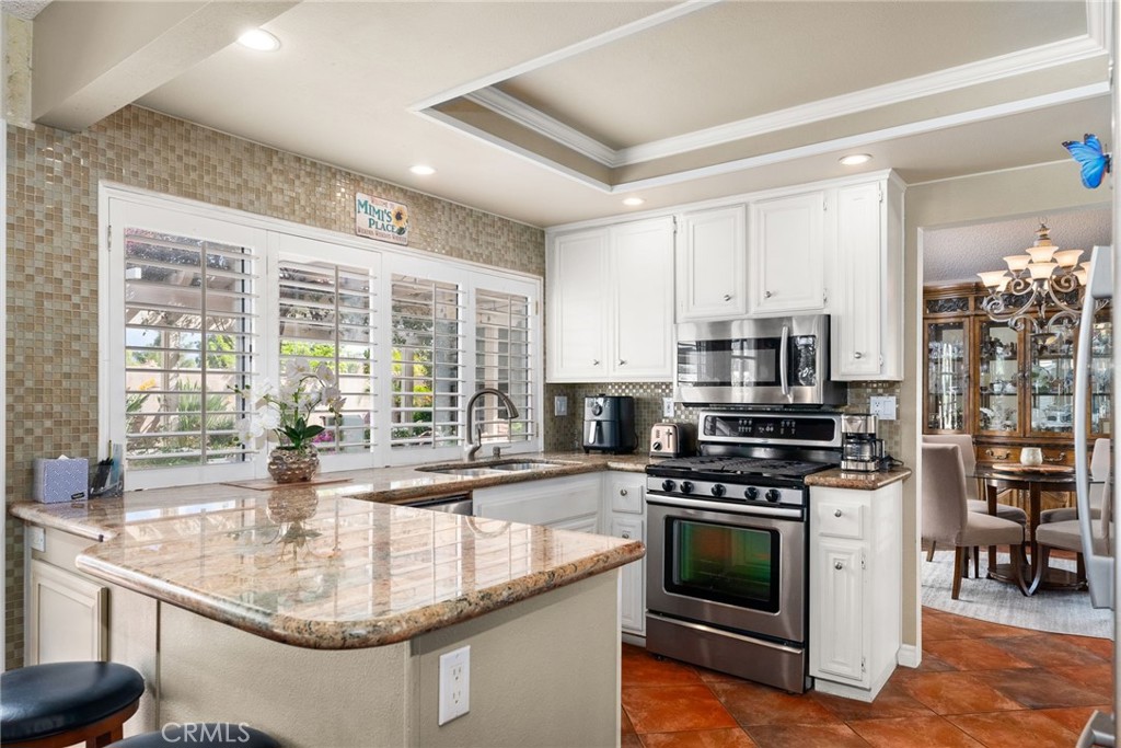 19422 Totem Court Riverside, CA 92508 - Photo 11 of 44 a kitchen with stainless steel appliances granite countertop a stove a sink and a microwave