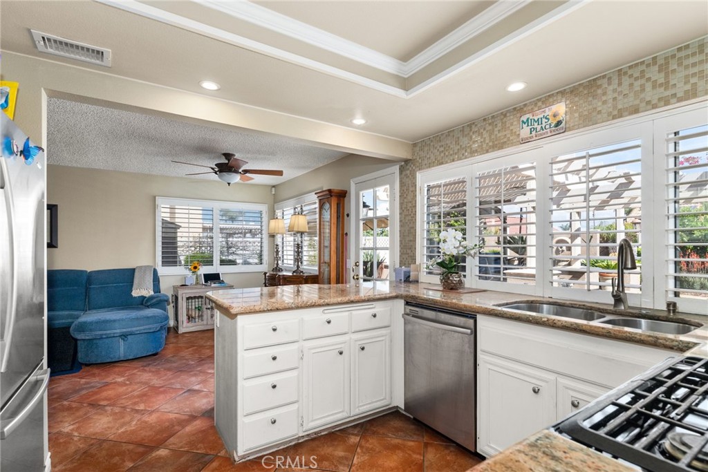 19422 Totem Court Riverside, CA 92508 - Photo 12 of 44 a kitchen with stainless steel appliances kitchen island granite countertop a sink and cabinets