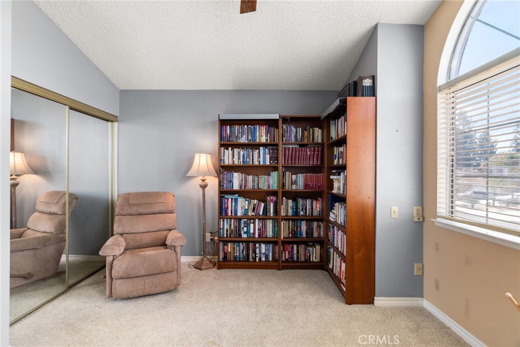 19422 Totem Court Riverside, CA 92508 - Photo 24 of 44 a living room with furniture and a book shelf