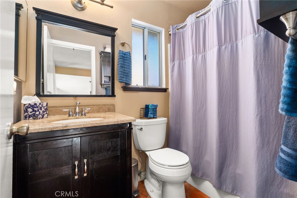 19422 Totem Court Riverside, CA 92508 - Photo 26 of 44 a bathroom with a granite countertop sink toilet and mirror