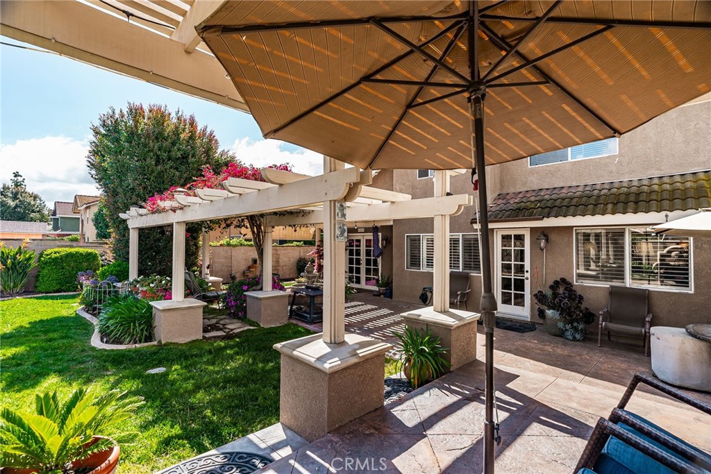 19422 Totem Court Riverside, CA 92508 - Photo 30 of 44 a view of a patio with table and chairs under an umbrella