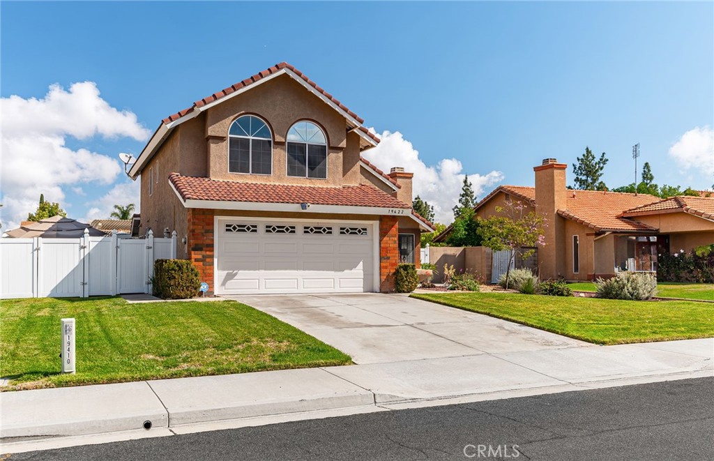 19422 Totem Court Riverside, CA 92508 - Photo 3 of 44 a front view of a house with a yard and garage