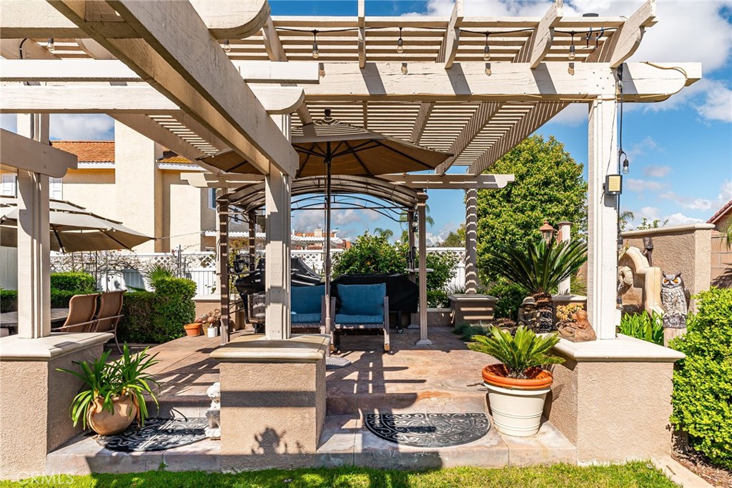 19422 Totem Court Riverside, CA 92508 - Photo 33 of 44 a view of a patio with table and chairs potted plants and floor to ceiling window