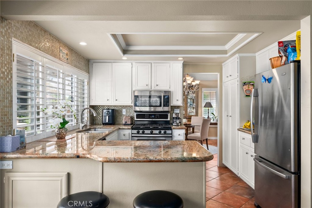 19422 Totem Court Riverside, CA 92508 - Photo 10 of 44 a kitchen with granite countertop a refrigerator and a sink