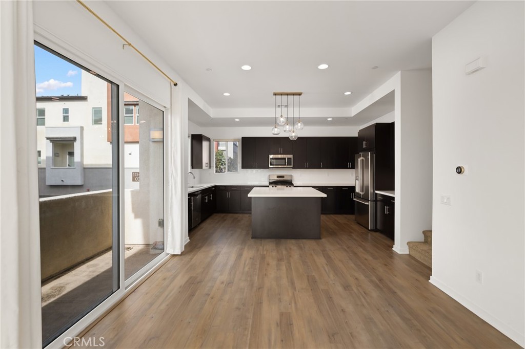 370 Broadway Drive Brea, CA 92821 - Photo 15 of 32 a large white kitchen with a large window a refrigerator and a view of living room