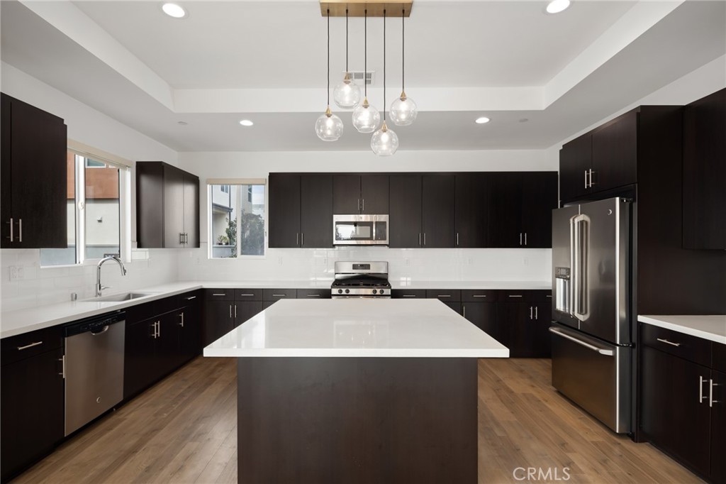370 Broadway Drive Brea, CA 92821 - Photo 16 of 32 a kitchen with kitchen island a sink stainless steel appliances and cabinets