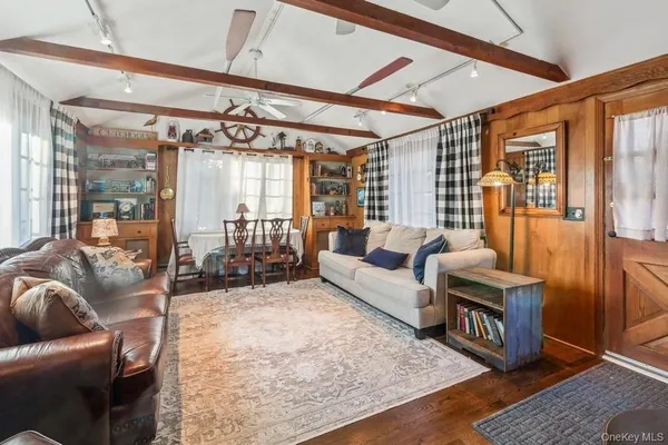 a living room with furniture rug and wooden floor