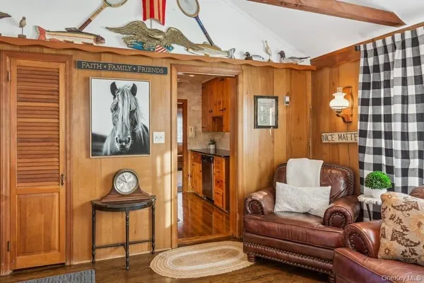 a living room with furniture and a painting on the wall