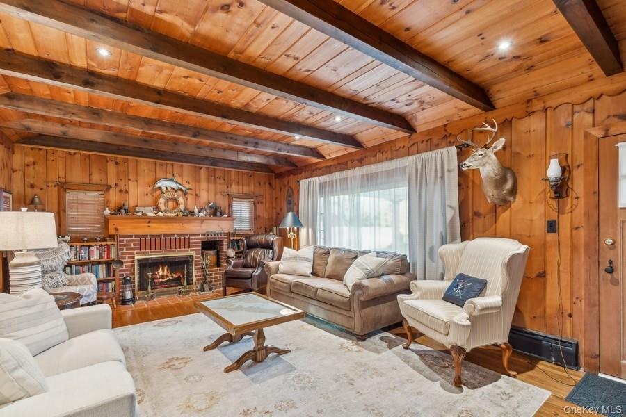 1850 Sterling Road Cutchogue, NY 11935 - Photo 22 of 28 a living room with furniture a fireplace and a large window