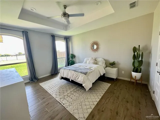 a bedroom with a bed couch and a window